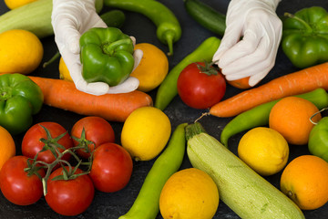 Choosing fruit with plastic medical gloves to protect from Covid-19 virus attack.