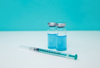 Glass medicine vials and syringe. Coronavirus, Covid 19 virus, vaccine
