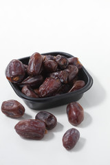 Dried dates fruits on white background, tasted sweet and chewy