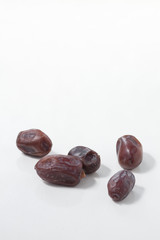Dried dates fruits on white background, tasted sweet and chewy