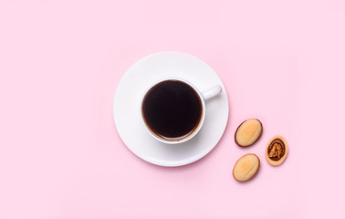 Homemade Russian nuts with condensed milk on a light pink background, wafer napkin. Cut nuts with condensed milk. Bitten goodies for coffee.