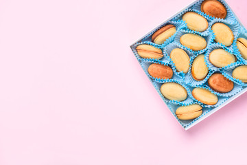 Homemade Russian nuts with condensed milk on a light pink background, wafer napkin. Cut nuts with condensed milk. Bitten goodies for coffee.