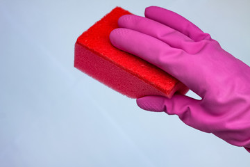 crimson glove for cleaning with a red wisp on a light background with a copy space