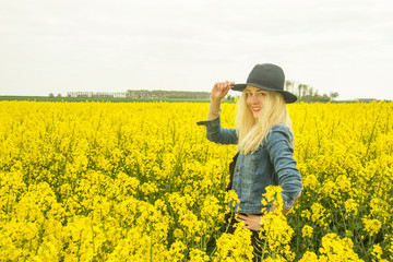 Fototapeta premium young woman in rape field
