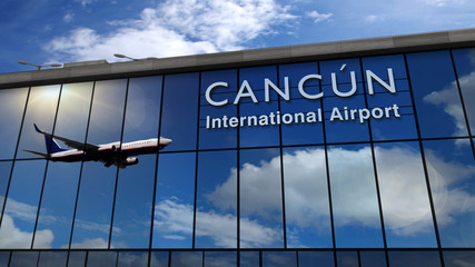 Airplane landing at Cancún Mexico mirrored in terminal