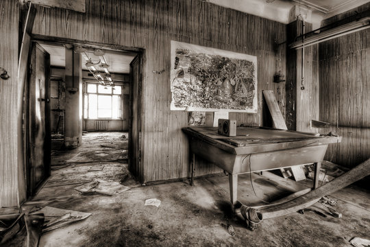 Room with billiards and radio in an old abandoned house