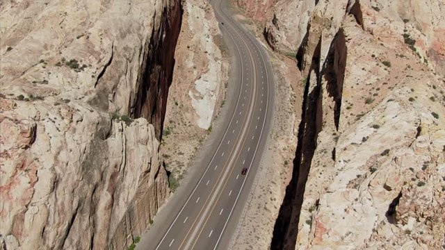 Aerial: Road going through The San Rafael Swell, a large geologic feature located in south-central Utah about 16 miles west of Green River, Utah.