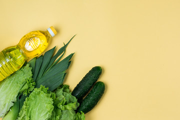 Essential fresh products lie on a yellow background. Greens food. Food delivery covid-19 epidemic, Donation. Top view. Copy space.
