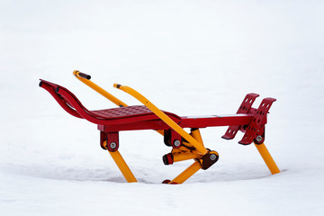 Outdoor exercise equipment covered in snow during the winter.