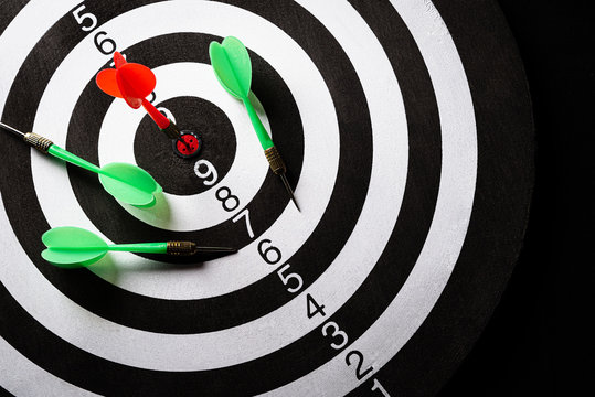 Top view of the target dartboard with arrows on dark background, business marketing, success, growth up and winner concept.