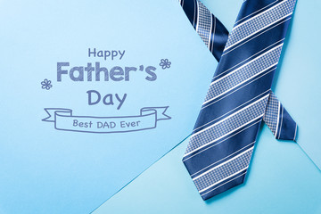 Happy Fathers Day background concept with blue necktie and the text " Happy Father's Day"  on bright pastel background.