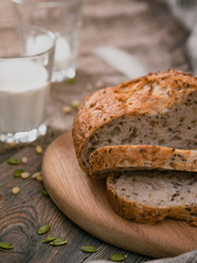 Bread and milk on planked wooden table. Vertical shot from above.