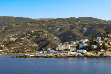 Fototapeta na wymiar The town of Armenistis at Ikaria Island from a boat in a chill summer day