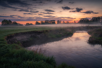Foggy sunrise in the Jeziorka river valley near Piaseczno, Poland