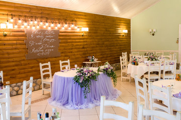 beautifully designed festive wedding table for the bride and groom with purple decor and flowers at the wedding