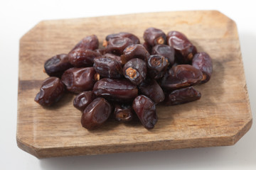 Dried dates fruits on white background, tasted sweet and chewy