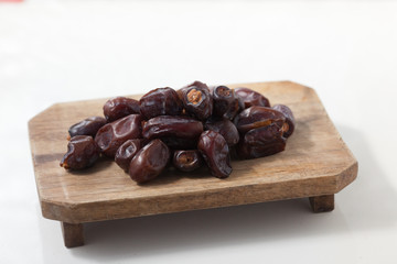 Dried dates fruits on white background, tasted sweet and chewy