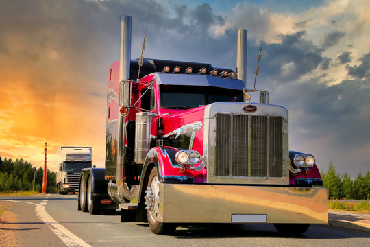 American Show Truck Tractor Peterbilt 379 trucking along highway against Sunset Sky. Illustrative Editorial Content. 