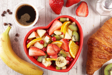 healthy breakfast with fresh fruit, croissant and coffee cup