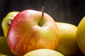 apples and pears on a dark background