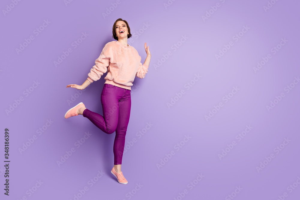 Wall mural Full body photo of cheerful glad girl have fun autumn free time vacation fool laughing wear good looking clothing isolated over violet color background