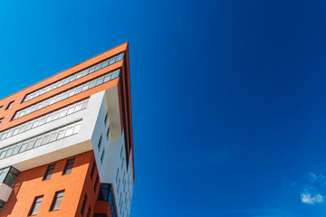 new modern architecture triangle exterior building red and white walls color foreshortening from below on vivid blue sky background space for copy or your text poster concept format