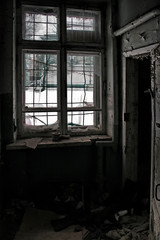 Fototapeta na wymiar Window with bars in an abandoned building