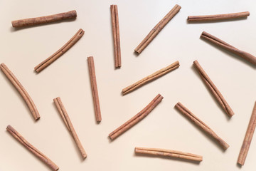 Top view of cinnamon sticks on brown background. Minimal. Flat layout.