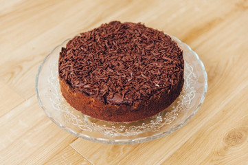 Chocolate Cake on the slass plate and wood background.