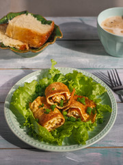 Homemade breakfast with scrambled eggs, salad and bread.