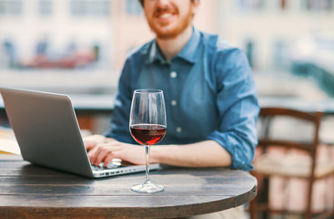 Hipster having a glass of wine at the bar