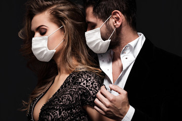 Couple in face mask in the tender passion