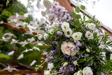 Obraz na płótnie Canvas Wooden round arch for the ceremony.Close-up of flower arrangements on the arch