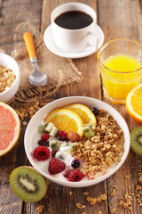 breakfast with cereal, fruit, orange juice and coffee cup