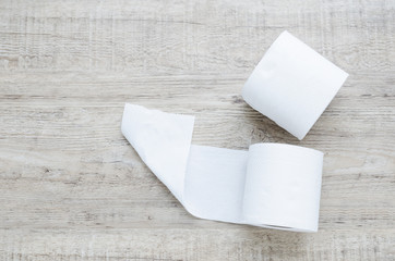 white toilet paper roll on wood background.