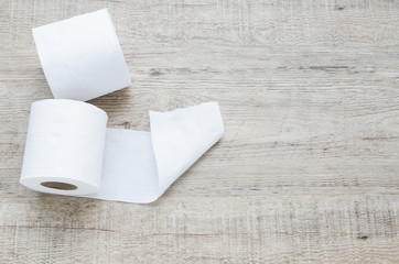 white toilet paper roll on wood background.