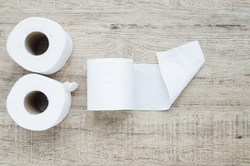 white toilet paper roll on wood background.