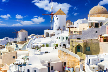 White architecture with the windmill of Oia town on Santorini island, Greece