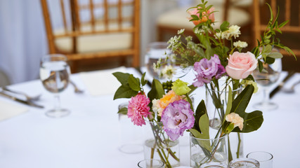 Flowers in glass on restaurant table