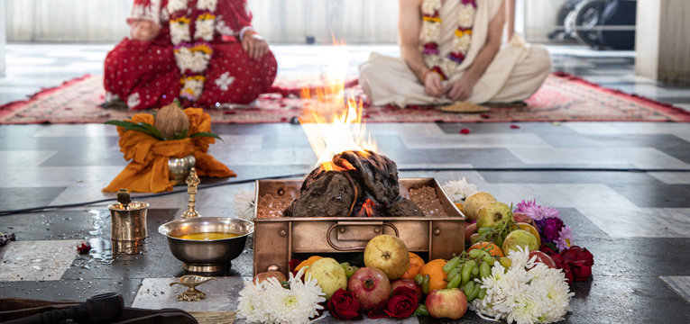 hindu bride and groom sit opposite fire during Indian Yajna ritual. authentic Vedic fire ceremony called Pooja. Indian tradition. Hindu wedding vivah Yagya.