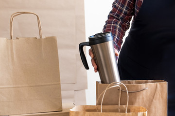 Worker delivery service packing bag box apron packer shipping open coffee to go
