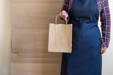 Worker delivery service packing bag box apron packer shipping open coffee to go