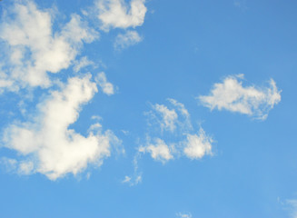 small white fluffy clouds in the blue sky. beautiful spring sky