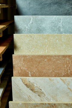 Various decorative tiles samples. Colorful samples of a stone tile in store. Copy space.