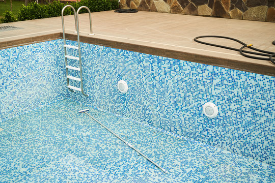 Empty Swimming Pool With Metal Ladder. Hotel Coronavirus Quarantine