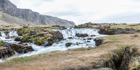 Large waterfall in Iceland surrounded by lava fields