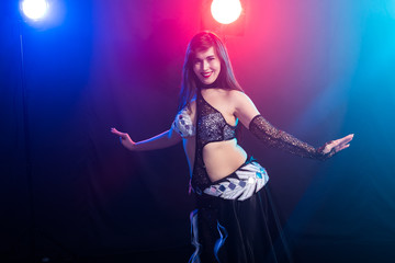Fototapeta premium Spirituality dance. Beautiful sexy woman with luxury glossy eastern make-up dancing tribal fusion. Belly dance.