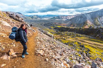 Fototapeta premium A young woman arriving at the volcanic ash valley from the 54 km trek from Landmannalaugar, Iceland