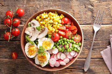 buddha bowl- vegetable salad with corn, tomato, radish and egg