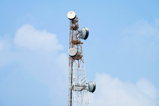 Telecommunication tower of 4G and 5G cellular. Macro Base Station. Wireless Communication Antenna Transmitter. Telecommunication tower with antennas against blue sky background.